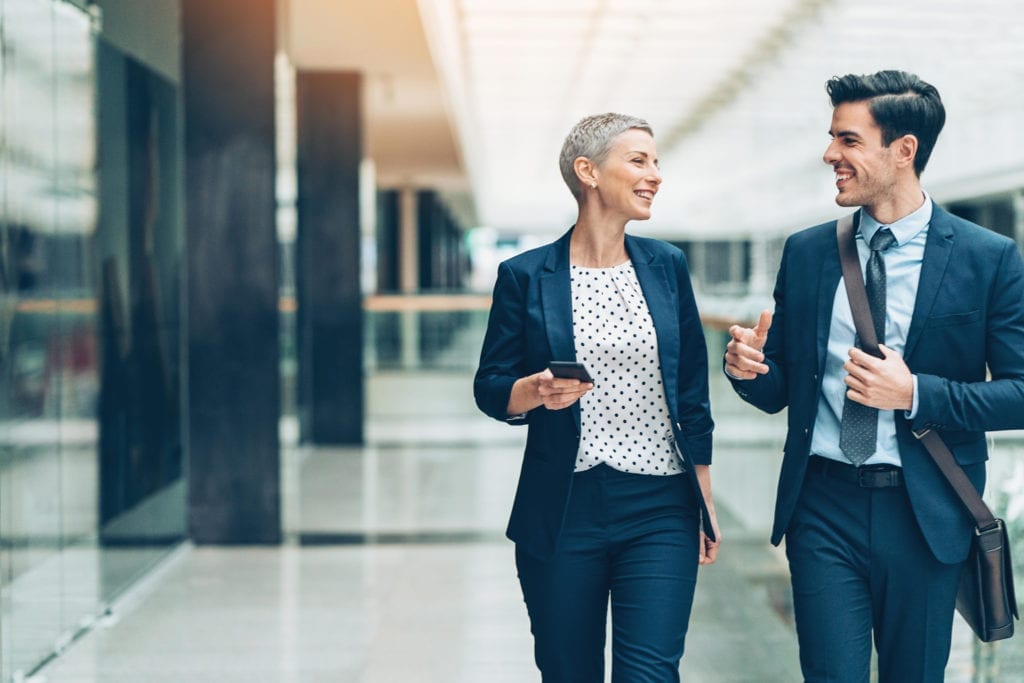 business man and woman talking and walking.