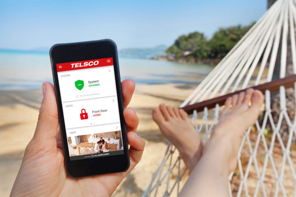 Person laying in hammock using telsco app on phone.